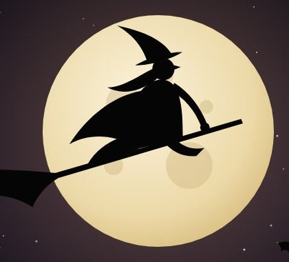 A witch on a broomstick across the full moon