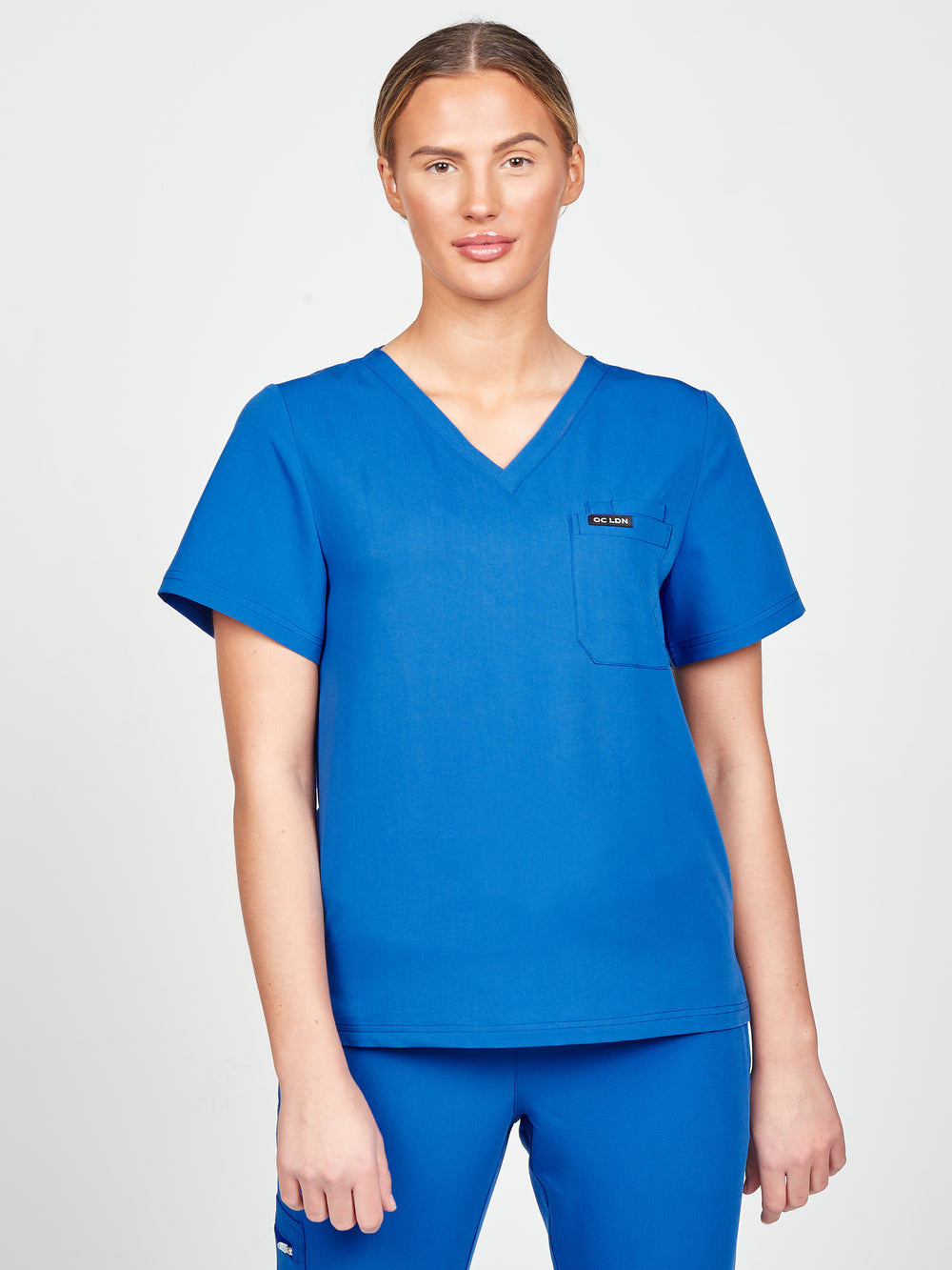 Woman wearing a royal blue scrub top
