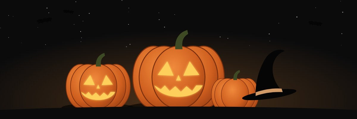 Three glowing jack-o'-lanterns and a witch's hat
